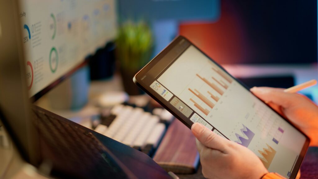 Tablet showing data analytics and monitoring dashboards.