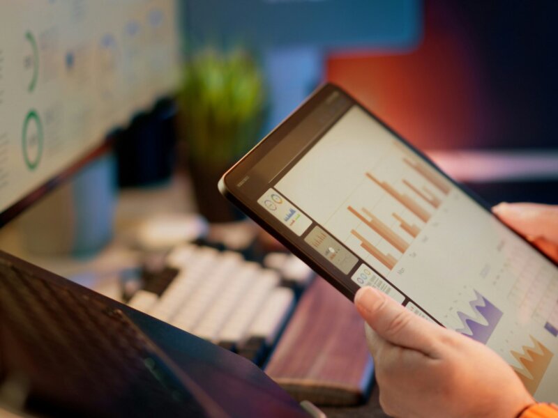 Tablet showing data analytics and monitoring dashboards.